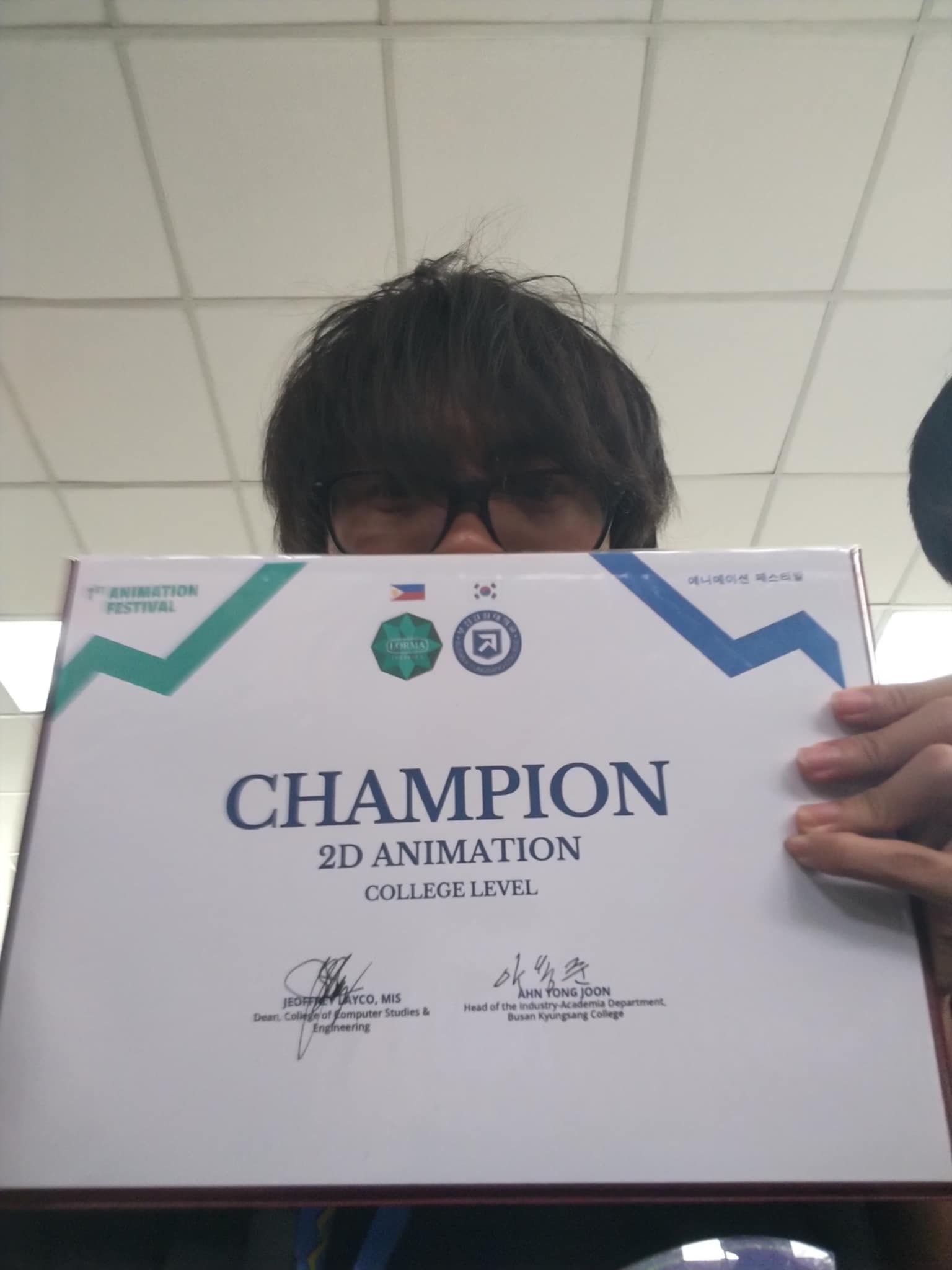 Jared holding his 1st Animation Festival Champion certificate