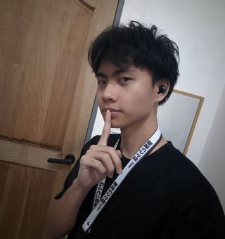 Jared Estabillo wearing a black shirt and university lanyard